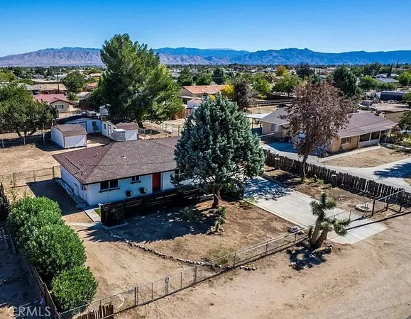 an aerial view of a house with a yard and lake view