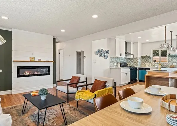 a living room with furniture and a kitchen view