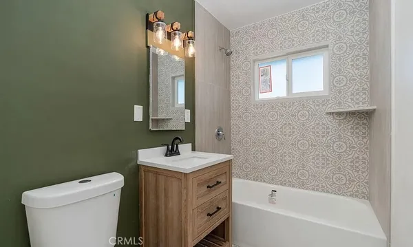 a bathroom with a sink toilet and tub