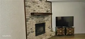 a living room with a fireplace and a flat screen tv