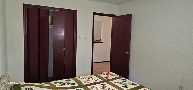 a bedroom with a bed and a wooden floor