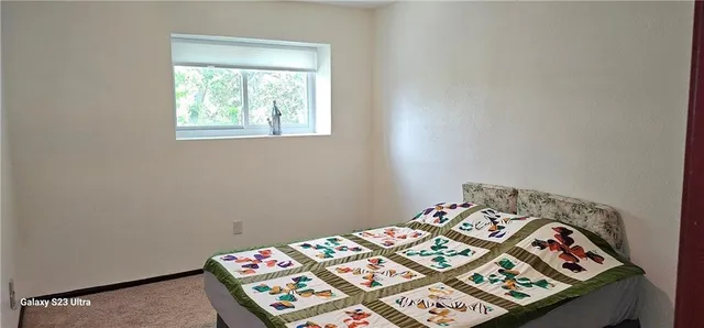 a bed in a bedroom next to a window