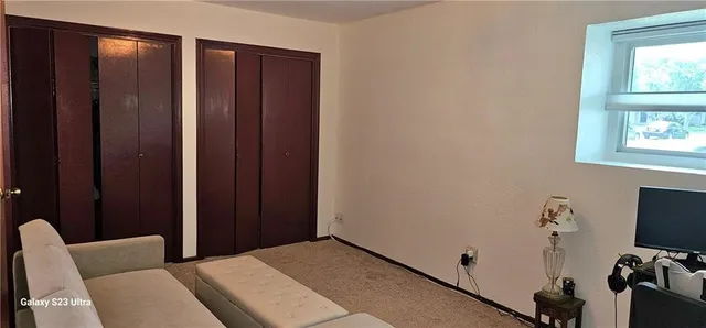 a bedroom with furniture and a window