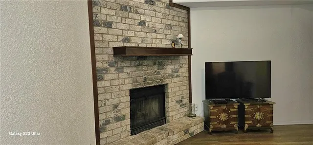 a living room with a fireplace and a flat screen tv