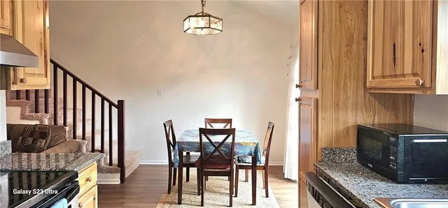 a view of a dining room with furniture window and wooden floor