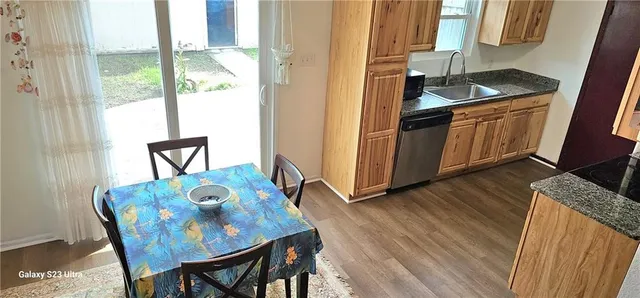a kitchen with granite countertop sink dining table and chairs
