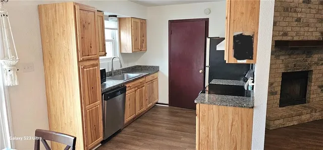 a kitchen with granite countertop a refrigerator and a stove