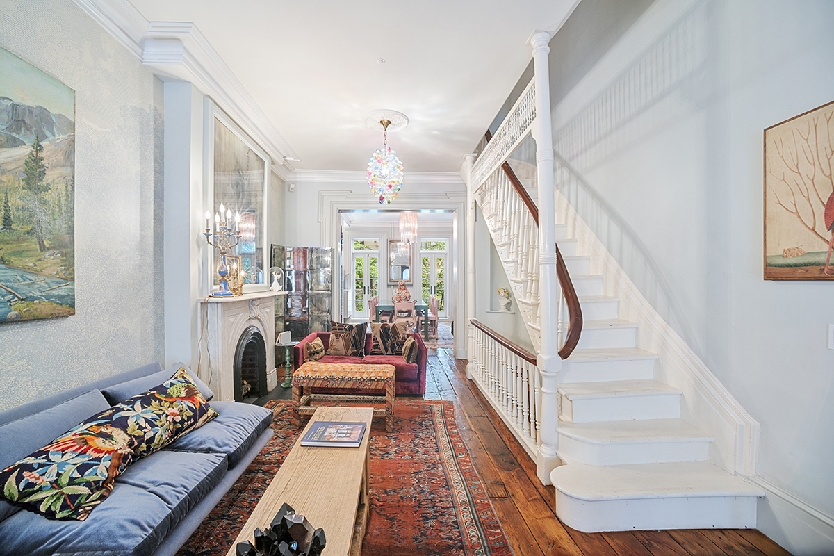 a living room with furniture fireplace and a large window