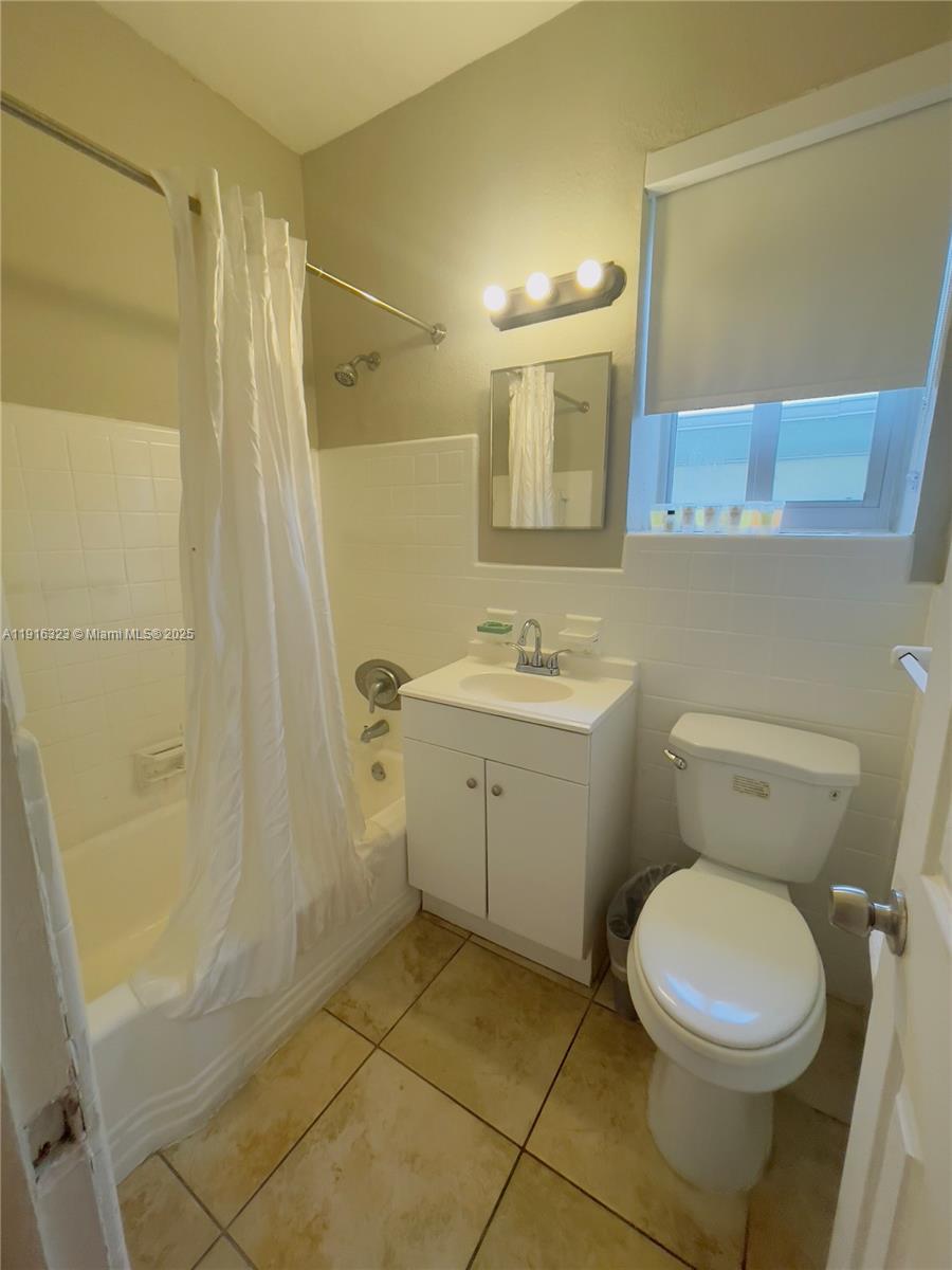8100 Harding Avenue, Unit 509 Miami Beach, FL 33141 - Photo 9 of 11 a bathroom with a toilet sink and a shower