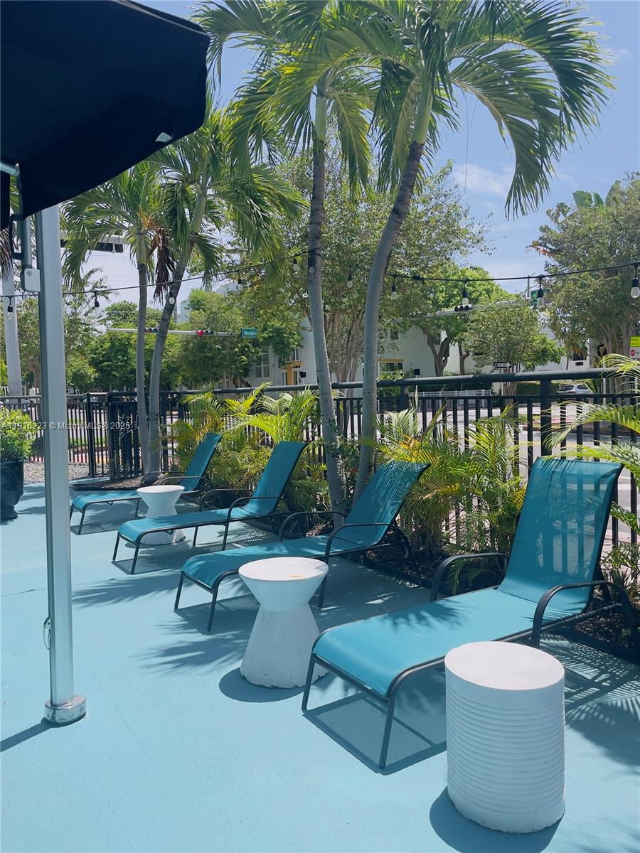 8100 Harding Avenue, Unit 509 Miami Beach, FL 33141 - Photo 10 of 11 a view of a patio with couches chairs and a potted plants