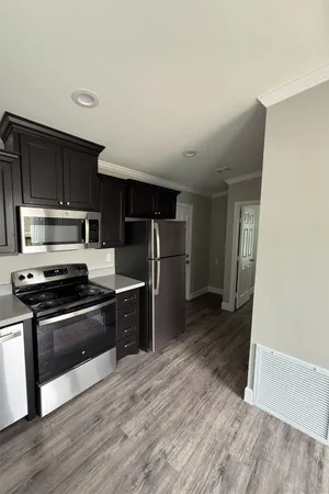 a kitchen with stainless steel appliances granite countertop a stove a refrigerator and a microwave