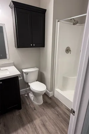 a white toilet sitting next to a bathroom sink