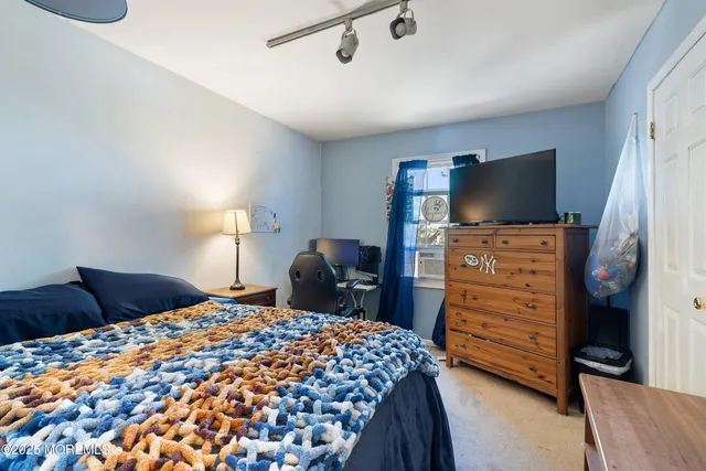 a bedroom with a bed and flat screen tv