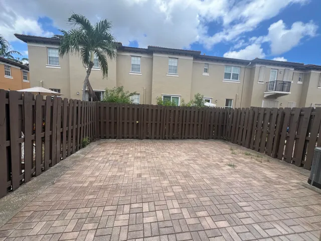 a view of a house with a wooden fence