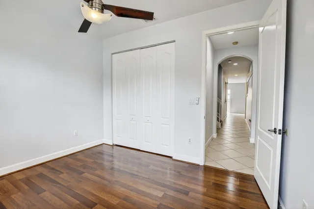 an empty room with wooden floor and mirror