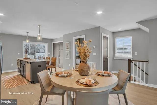 a view of a dining room with furniture and wooden floor