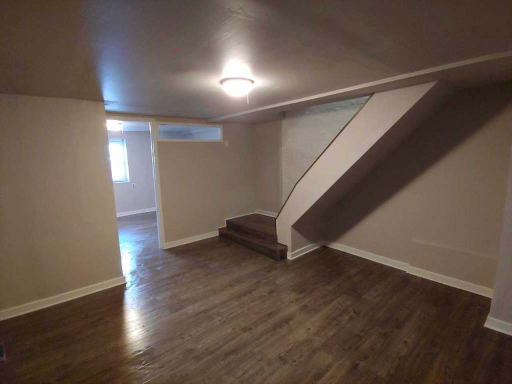 2655 West 24th Place Chicago, IL 60608 - Photo 5 of 16 an empty room with wooden floor and windows