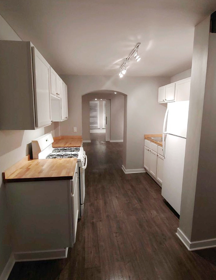 2655 West 24th Place Chicago, IL 60608 - Photo 6 of 16 a kitchen with stainless steel appliances granite countertop a sink stove and refrigerator