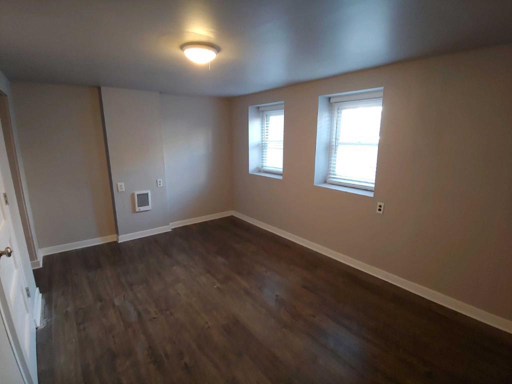 2655 West 24th Place Chicago, IL 60608 - Photo 9 of 16 an empty room with wooden floor and windows