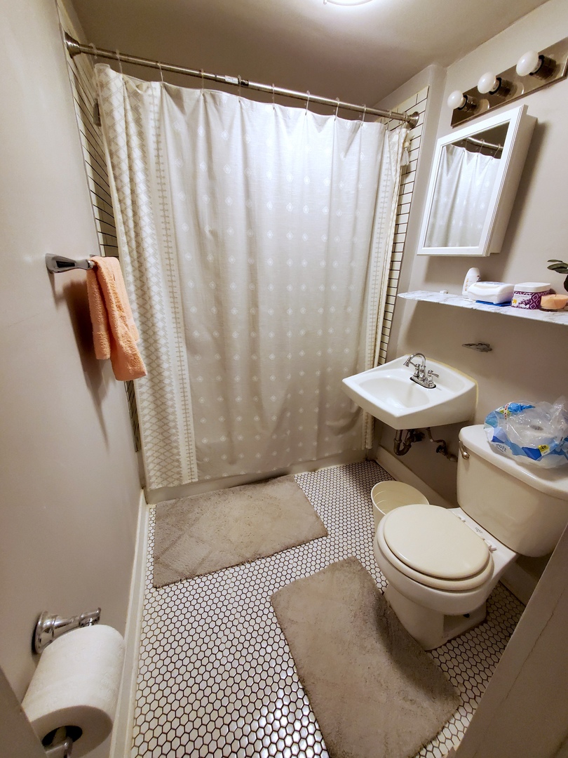 2655 West 24th Place Chicago, IL 60608 - Photo 10 of 16 a bathroom with a toilet a sink and a shower