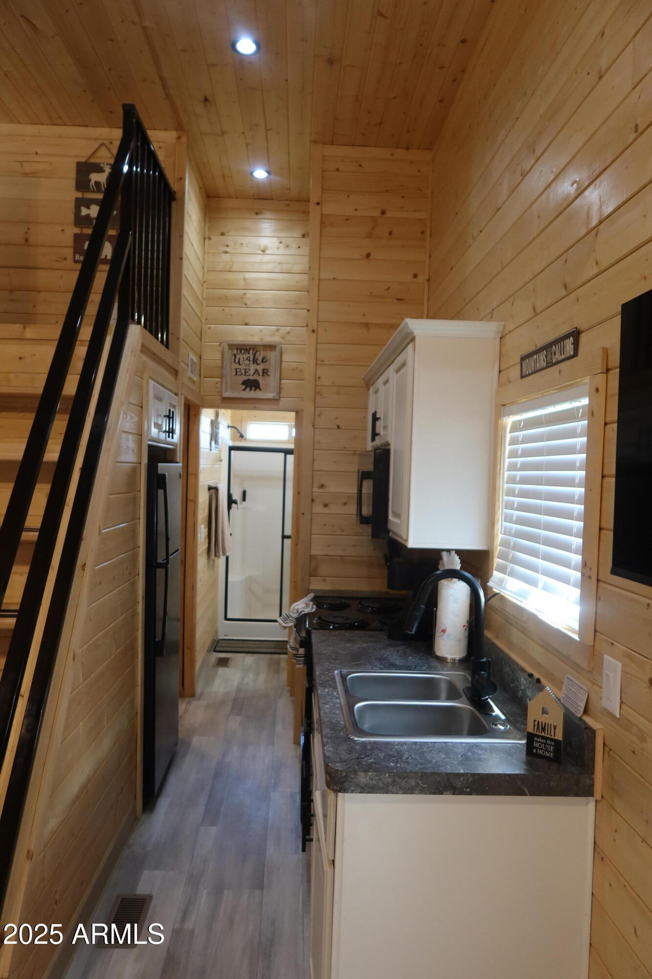 2746 Columbia Lane, Unit 10 Overgaard, AZ 85933 - Photo 15 of 33 a kitchen with a sink and wooden floor