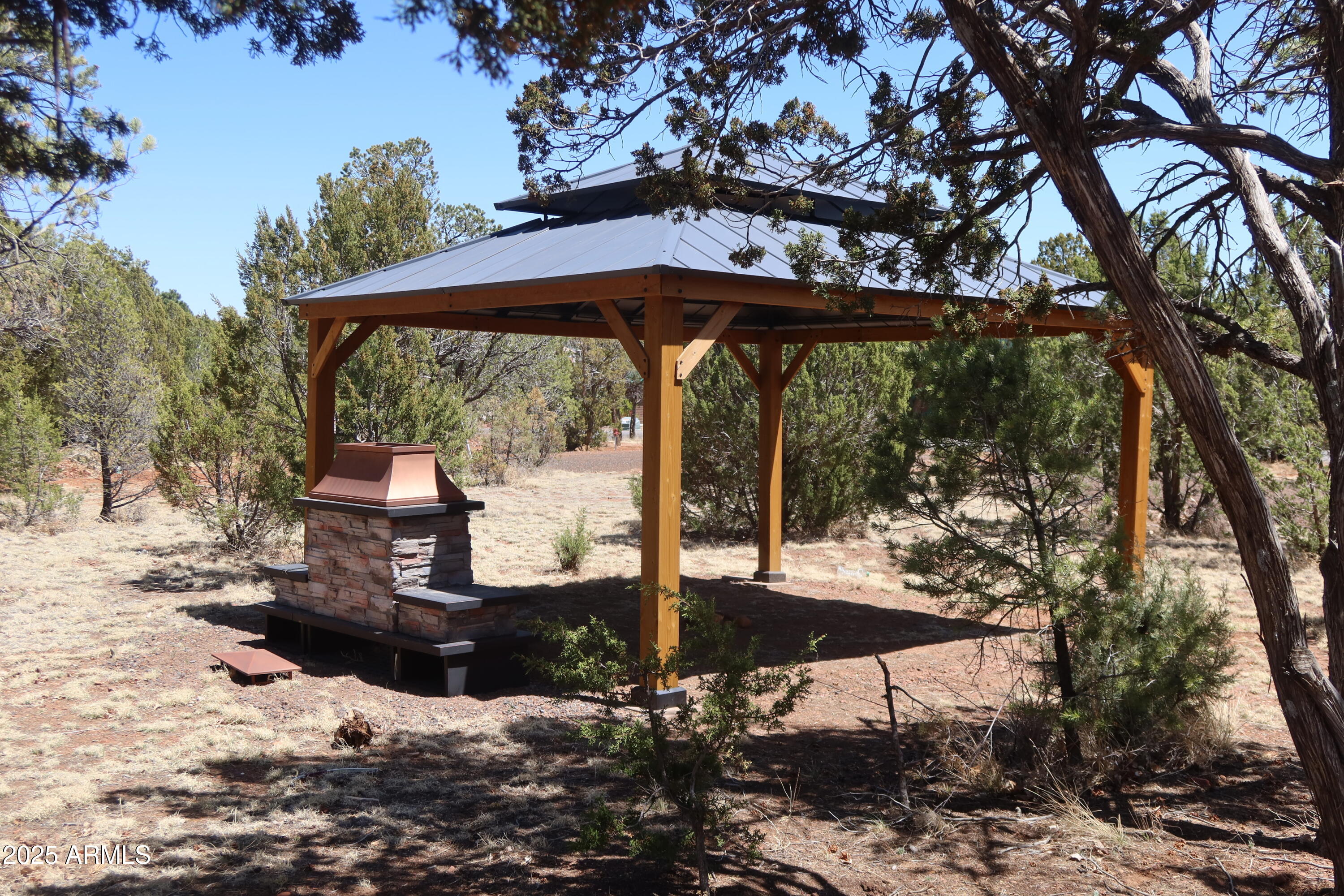 2746 Columbia Lane, Unit 10 Overgaard, AZ 85933 - Photo 32 of 33 a view of a patio with a table chairs and a yard
