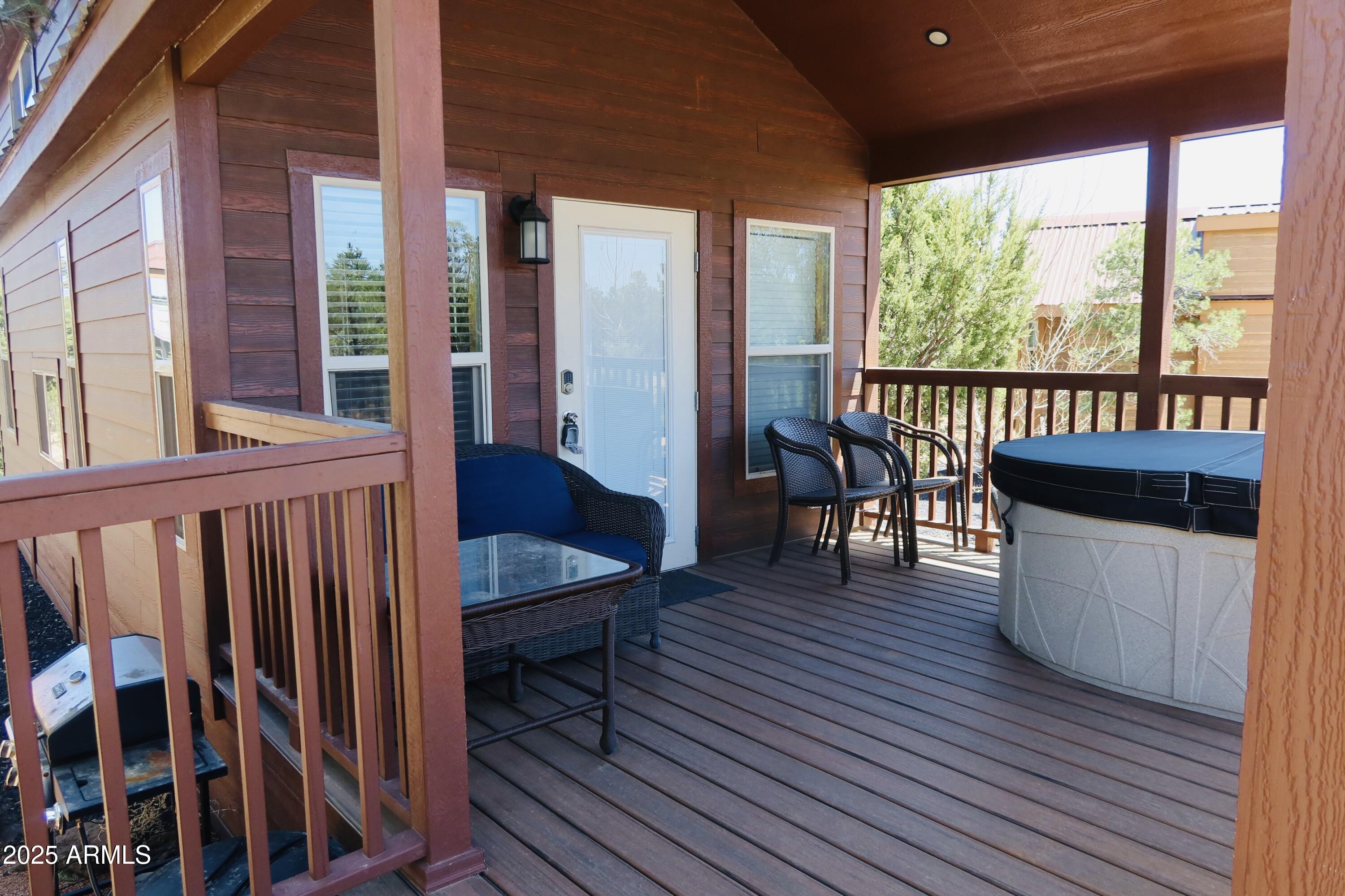 2746 Columbia Lane, Unit 10 Overgaard, AZ 85933 - Photo 9 of 33 a view of a balcony with furniture and wooden floor