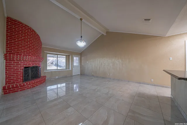 a view of livingroom with fireplace and window