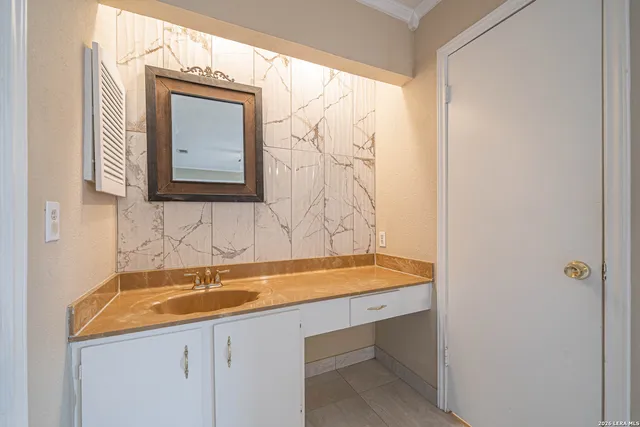 a bathroom with a sink and a mirror