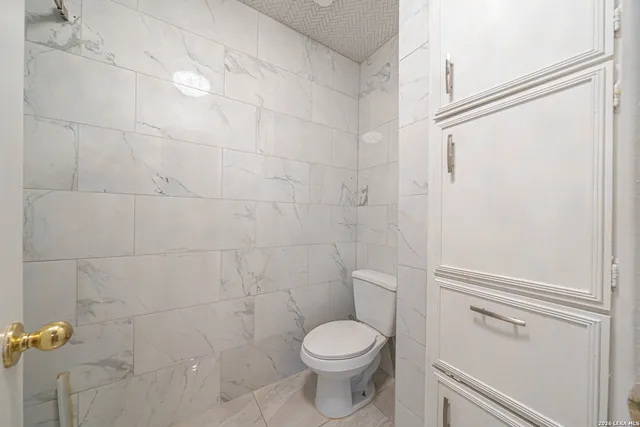 a white toilet sitting next to a bathroom sink