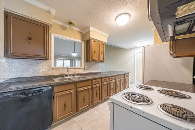 a kitchen that has a sink and a stove