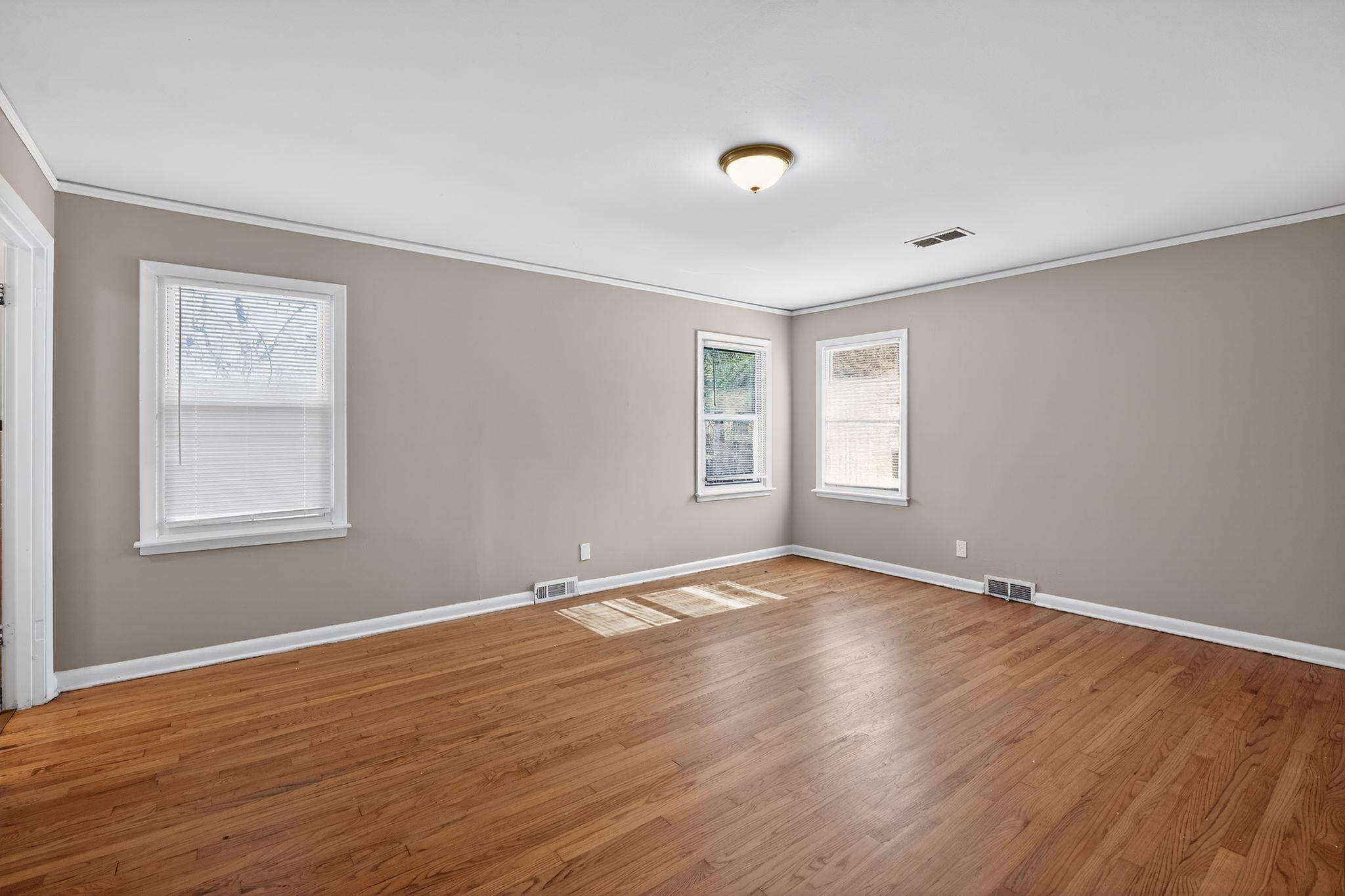 4094 Auburn Road Memphis, TN 38116 - Photo 11 of 30 a view of an empty room with wooden floor and a window
