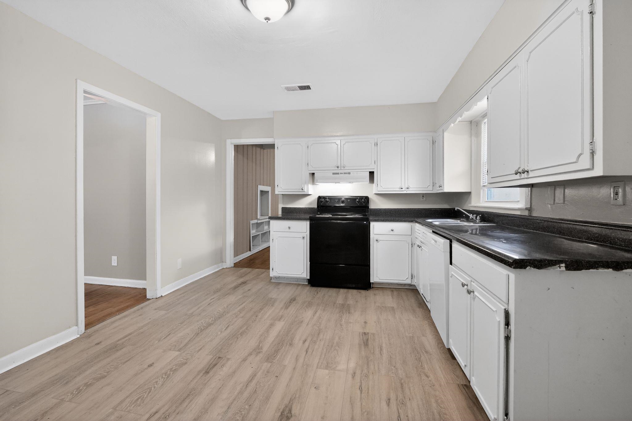 4094 Auburn Road Memphis, TN 38116 - Photo 14 of 30 a kitchen with stainless steel appliances granite countertop a stove a sink and a refrigerator