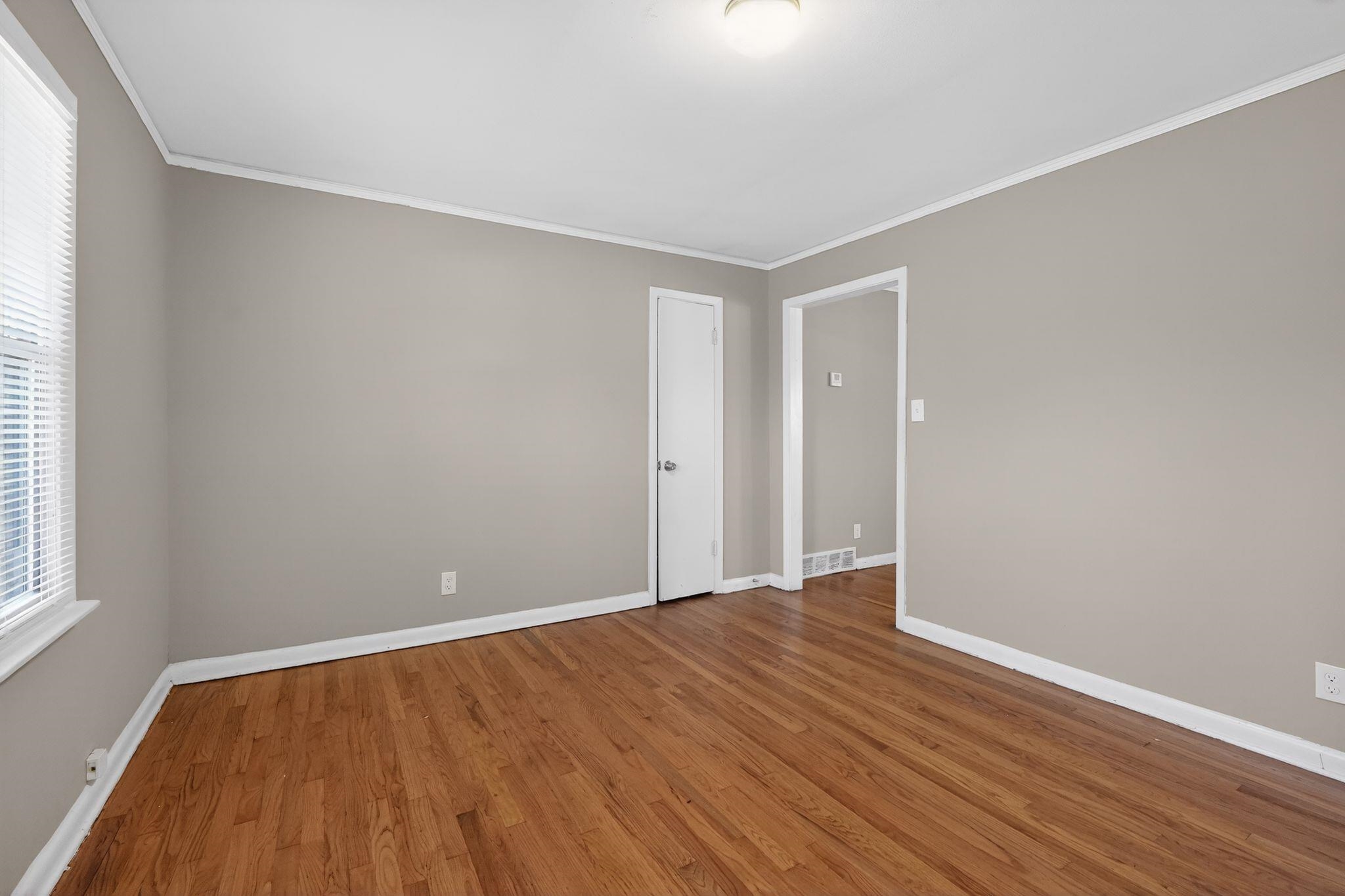 4094 Auburn Road Memphis, TN 38116 - Photo 4 of 30 a view of an empty room with wooden floor and a window