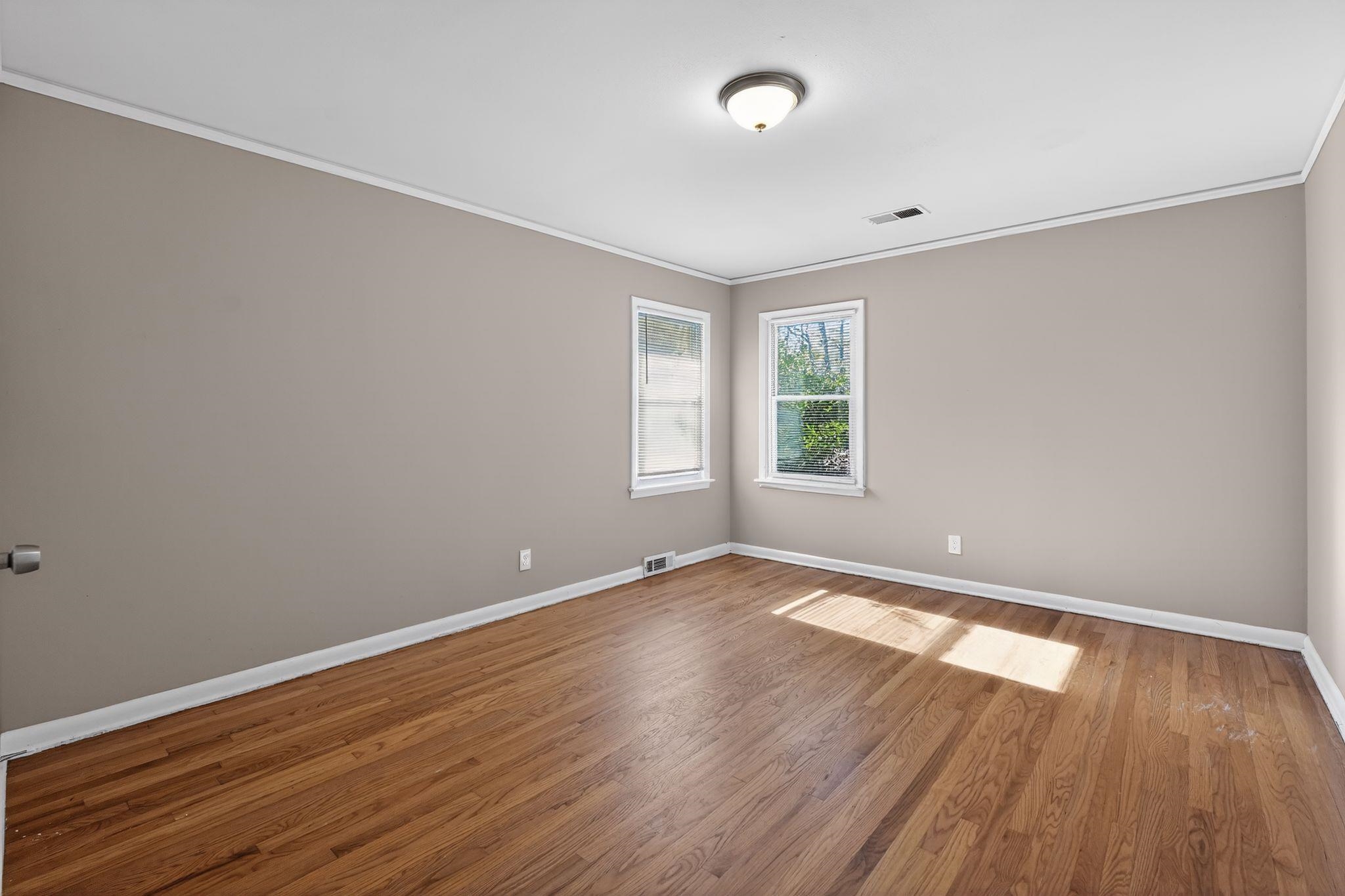 4094 Auburn Road Memphis, TN 38116 - Photo 7 of 30 an empty room with wooden floor and windows