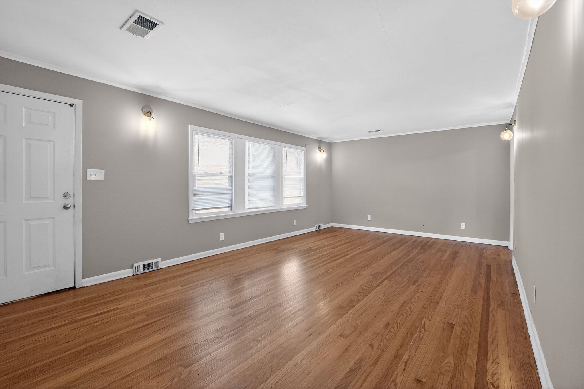 4094 Auburn Road Memphis, TN 38116 - Photo 10 of 30 a view of an empty room with wooden floor and a window