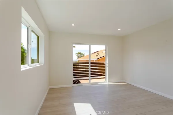 a view of a room with wooden floor and windows