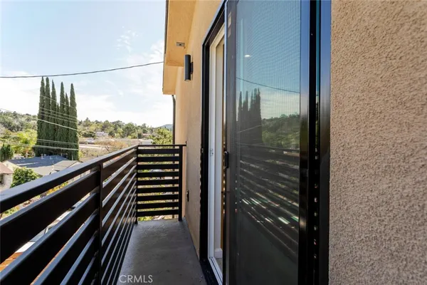 a view of a balcony with wooden floor and fence