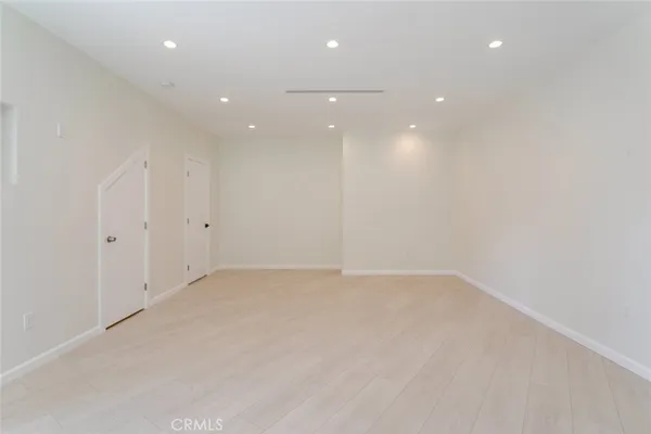a view of a kitchen with a sink and a refrigerator