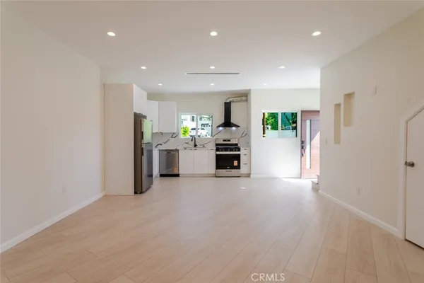 a view of kitchen with furniture and refrigerator