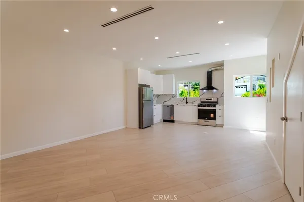 a kitchen with white cabinets and white appliances
