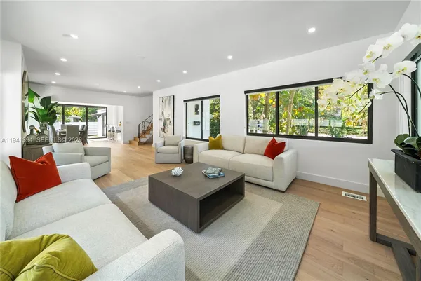 a living room with furniture and a large window