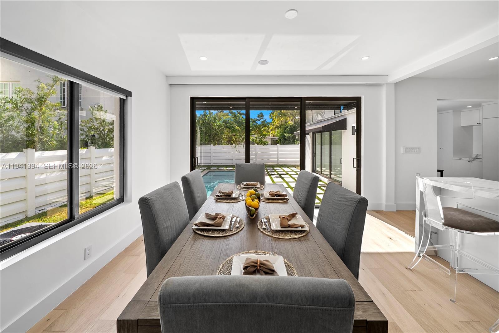 600 Northeast 57th Street Miami, FL 33137 - Photo 11 of 43 a dining room with furniture a large window and a potted plant