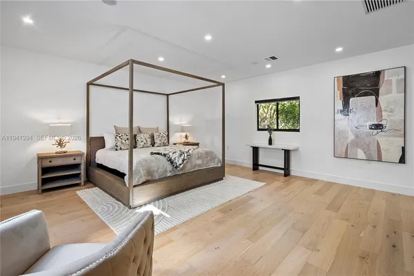 a bedroom with a bed window and couch