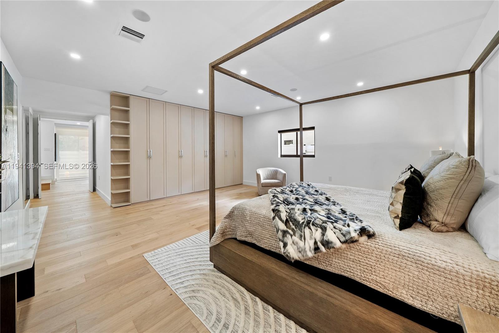 600 Northeast 57th Street Miami, FL 33137 - Photo 21 of 43 a bedroom with a large bed and a chandelier