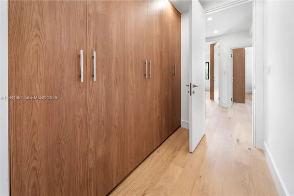 a view of a hallway with wooden floor