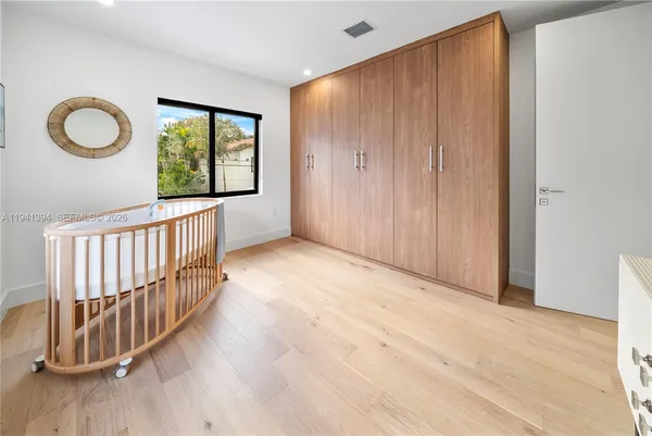 a view of a room with wooden floor and windows
