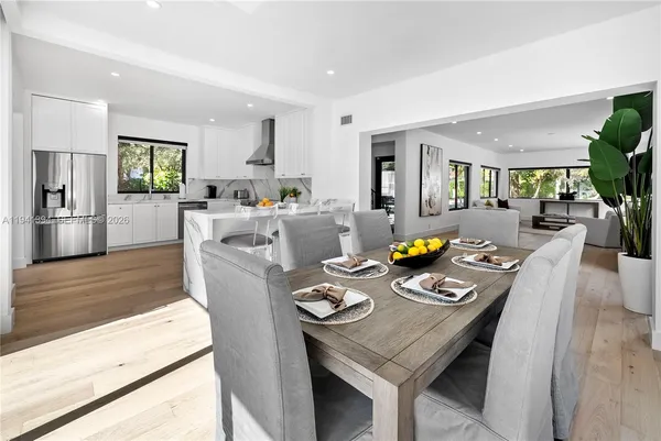 a living room with furniture a window and kitchen view