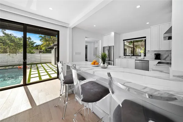 a kitchen with a sink and a large window