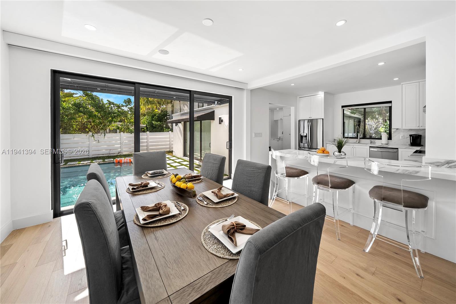 600 Northeast 57th Street Miami, FL 33137 - Photo 10 of 43 a view of a dining room with furniture large windows and wooden floor